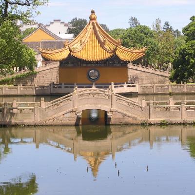 Chinese temple next to a body of water Chinese temple next to a body of water